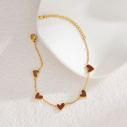 Pulsera de acero inoxidable chapada en oro, con diseño de corazones multicolor estilo gotas de aceite. Joyería llamativa y moderna