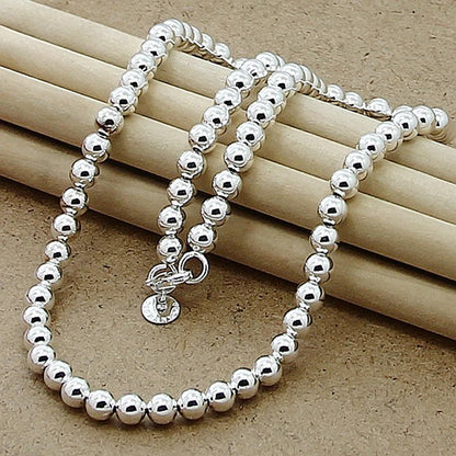 💎 Collar JewelryTop de plata esterlina 925 con cuentas lisas de 6 mm en cadena tipo bola. Longitud 45 cm, diseño elegante y moderno, ideal para mujer en bodas, compromisos o como joya de moda.