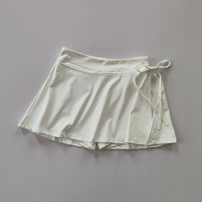Falda deportiva estilo yoga con pantalón integrado: ideal para tenis, bádminton o entrenamiento. Secado rápido, con bolsillo lateral y abertura moderna para máxima comodidad y estilo.